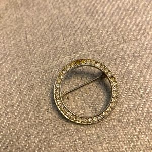 Circle pin rhinestone chrome pave’ set. Pretty over an inch